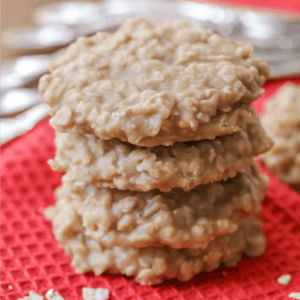 Stacked peanut butter no bake cookies on a red towel.