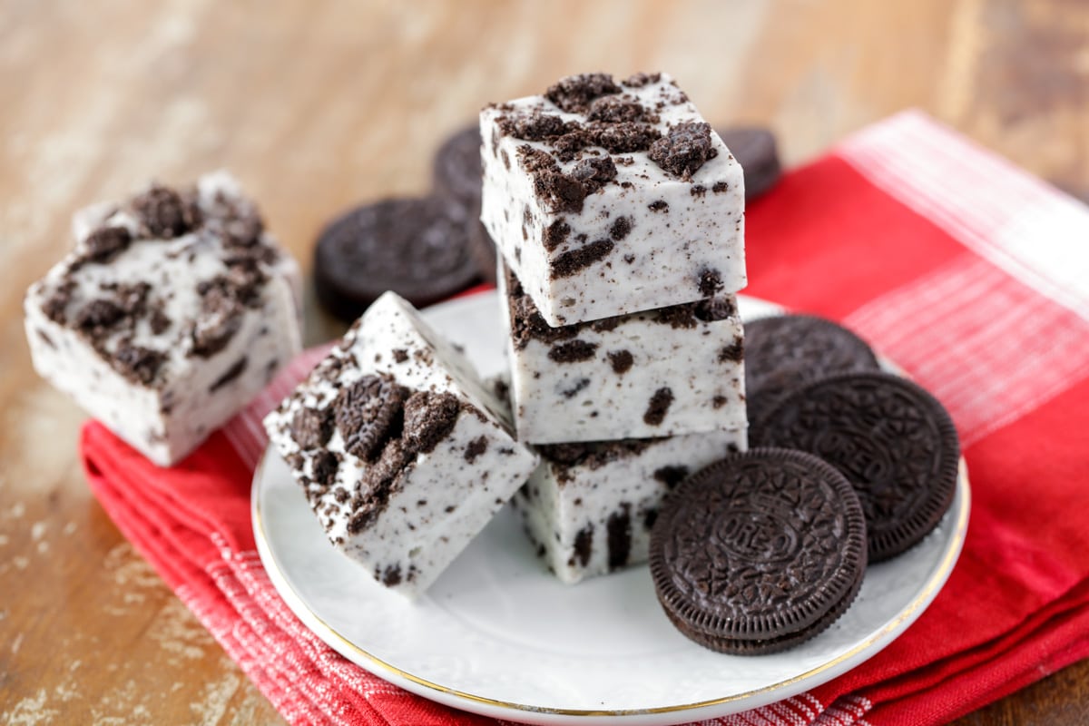 Oreo fudge cut and stacked on a white plate.