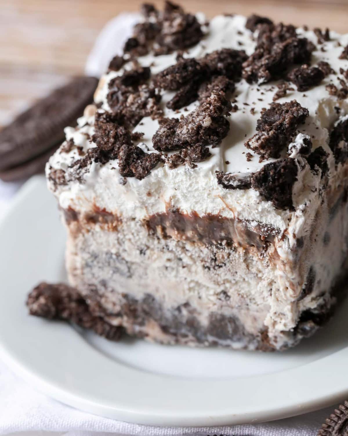 Easy Oreo Ice Cream Cake Recipe cut and served on a white plate.