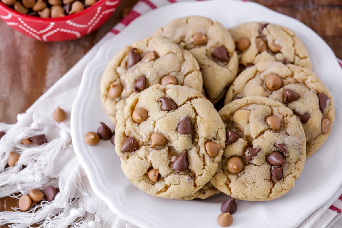 Easy cookie recipes - peanut butter chocolate chip cookies piled on a white plate.