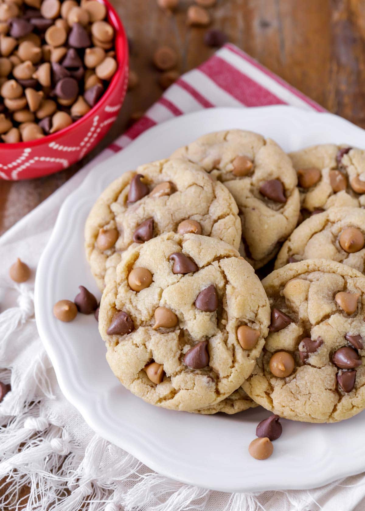 peanut butter chocolate chip cookies stacked on a white plate