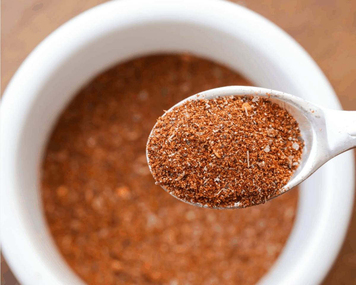 A white bowl filled with homemade taco seasoning.