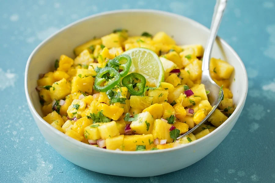 Mango Salsa recipe served in a white bowl.