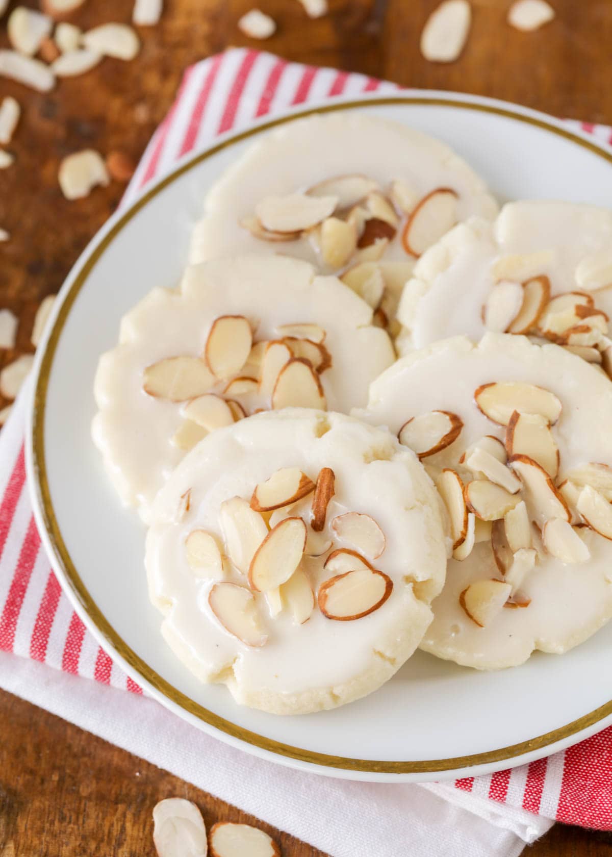 Almond cookie recipe topped with sliced almonds on a white plate
