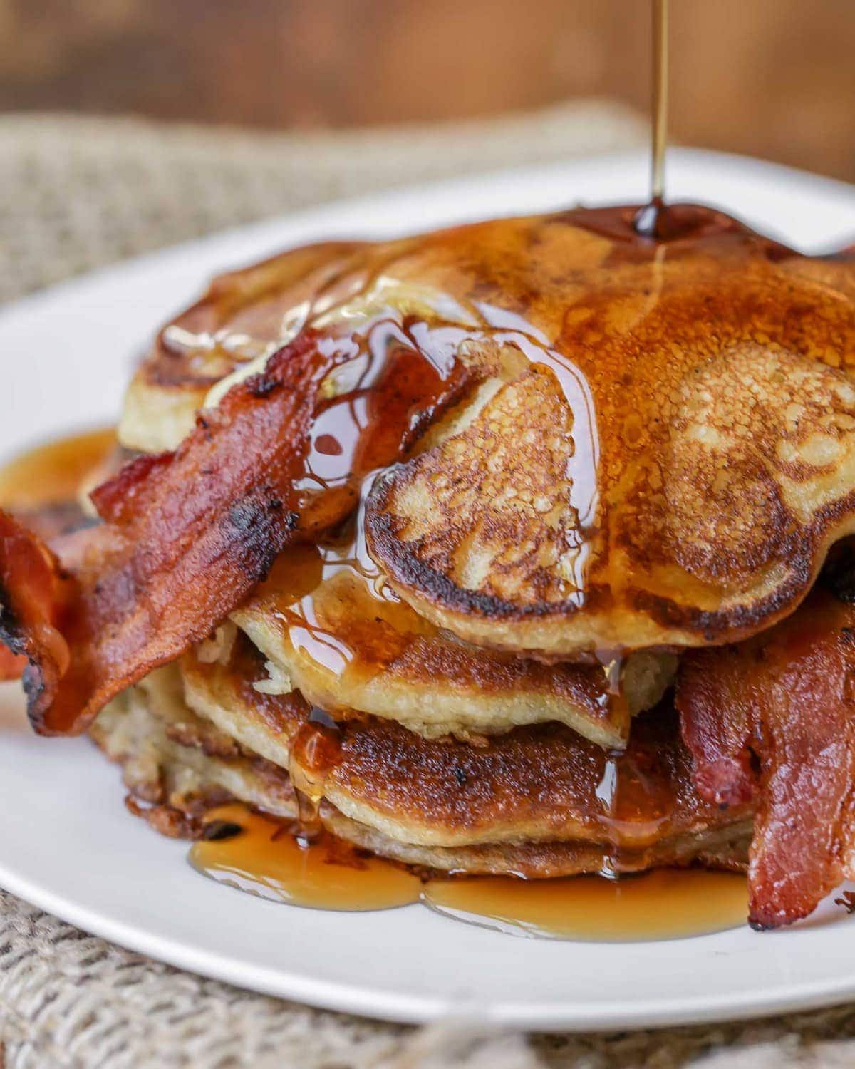 Bacon Pancakes Recipe covered in maple syrup