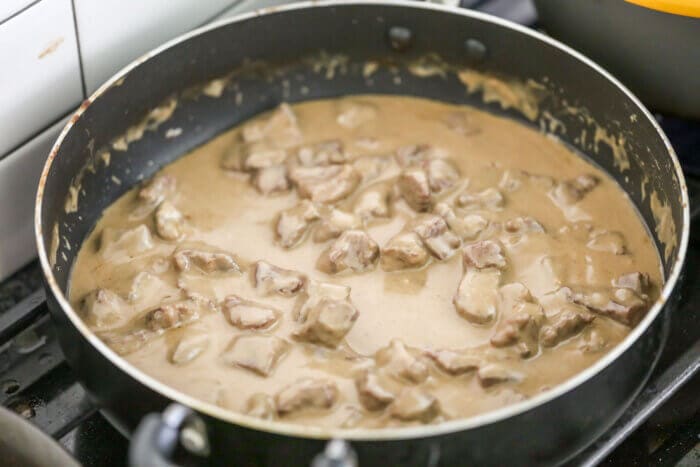 This easy beef stroganoff recipe is simple and flavorful. Served with egg noodles, this creamy stroganoff is a classic dinner recipe perfect for enjoying any night of the week. Homemade beef stroganoff in skillet.
