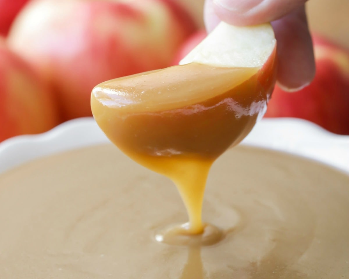 New Year's Eve Appetizers - an apple dipped into caramel apple dip.
