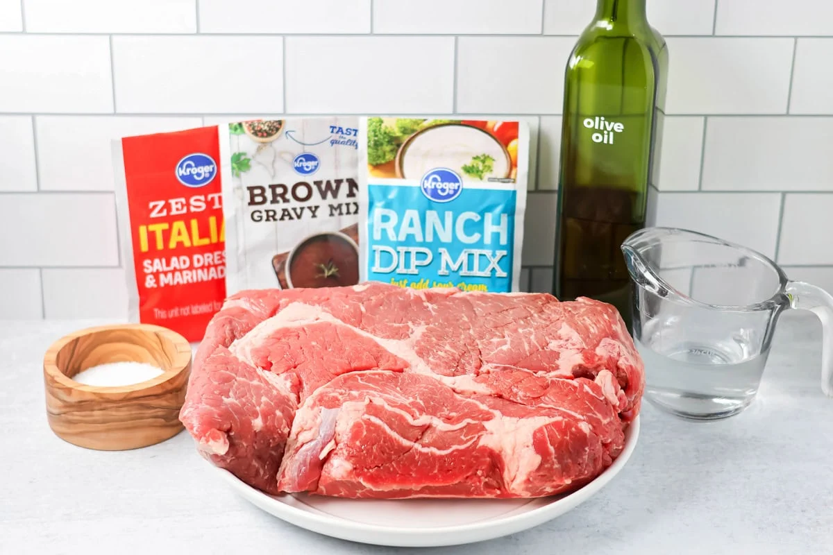 Crock pot pot roast ingredients on counter.