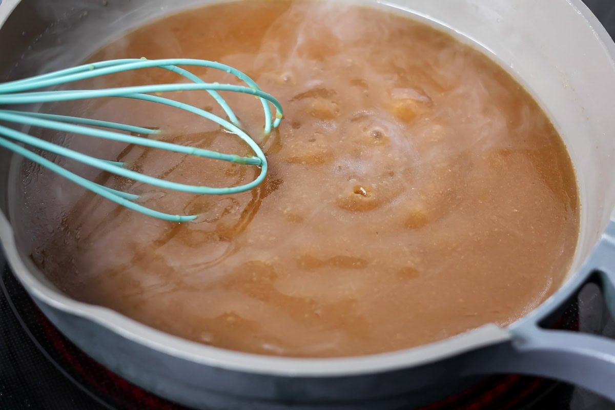 Pot roast gravy being made in skillet.