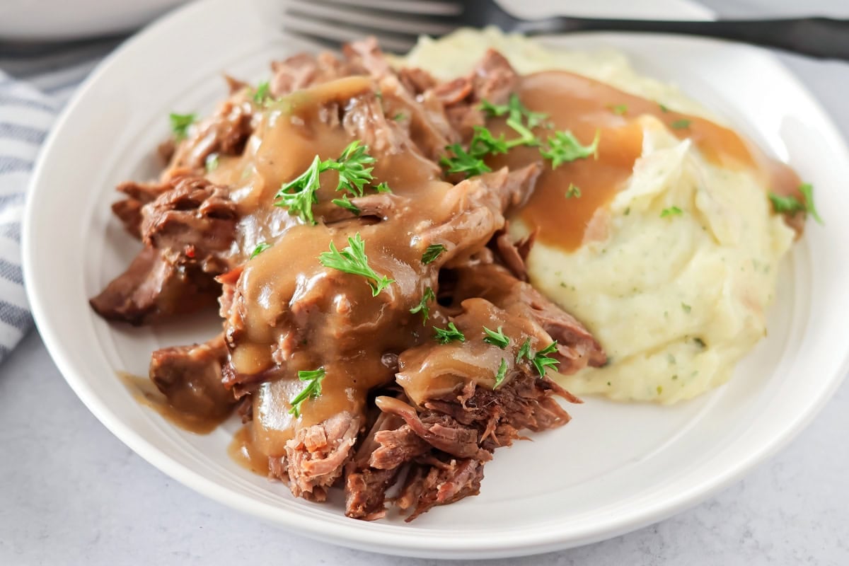 Crock pot roast recipe with mashed potatoes and gravy.