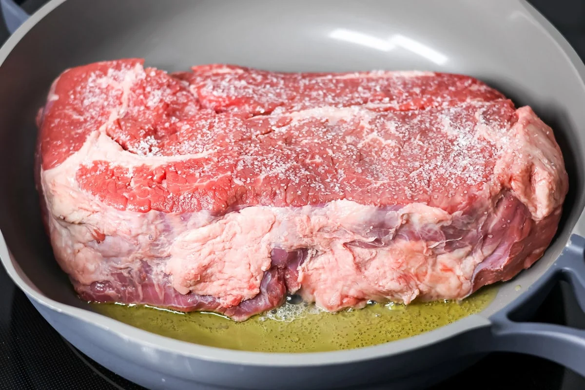 Roast being browned in skillet.