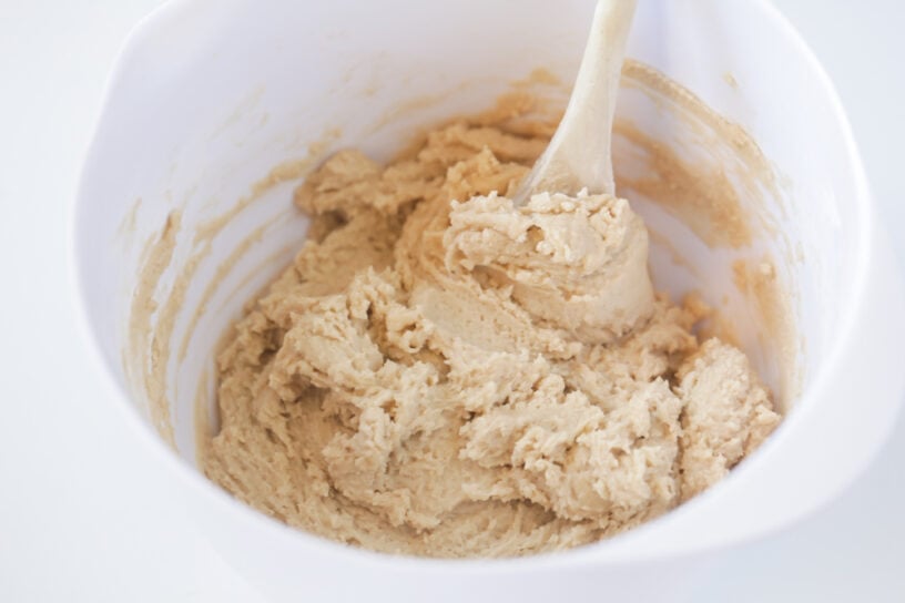 Grab a Spoon! This Eggless Cookie Dough recipe is for all the cookie dough lovers out there! With NO eggs included in this recipe, you can use this edible cookie dough in shakes, fudge, brownies, or eat it all by itself!! Cookie dough batter mixed in a white bowl.
