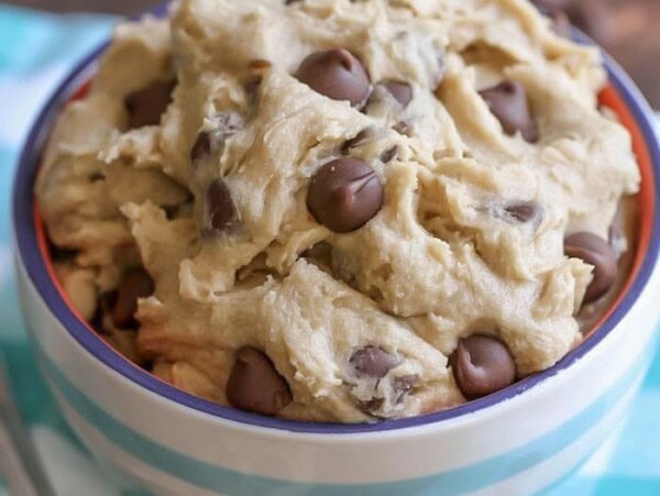 A blue and white striped bowl of eggless cookie dough.