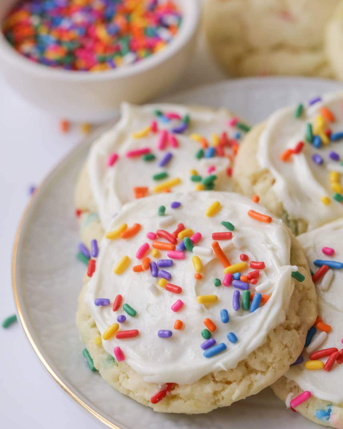 Funfetti Cookies stacked on a white plate.