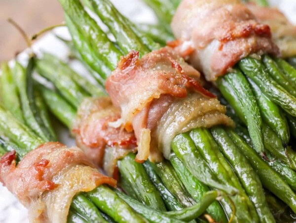 Green bean bundles on a plate.