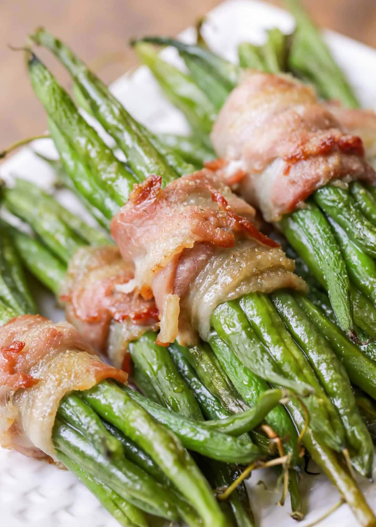 Green Beans bundles wrapped in bacon and served on a platter.