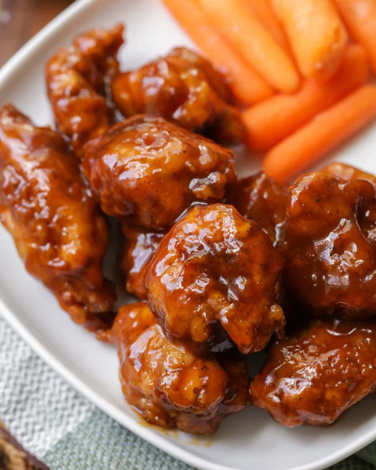 Honey bbq Boneless Wings served on a plate with carrots.