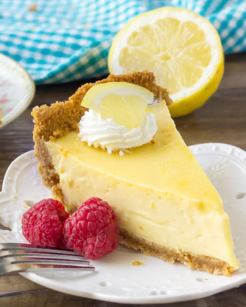 Lemon Icebox Pie served on a white plate topped with whipped cream.