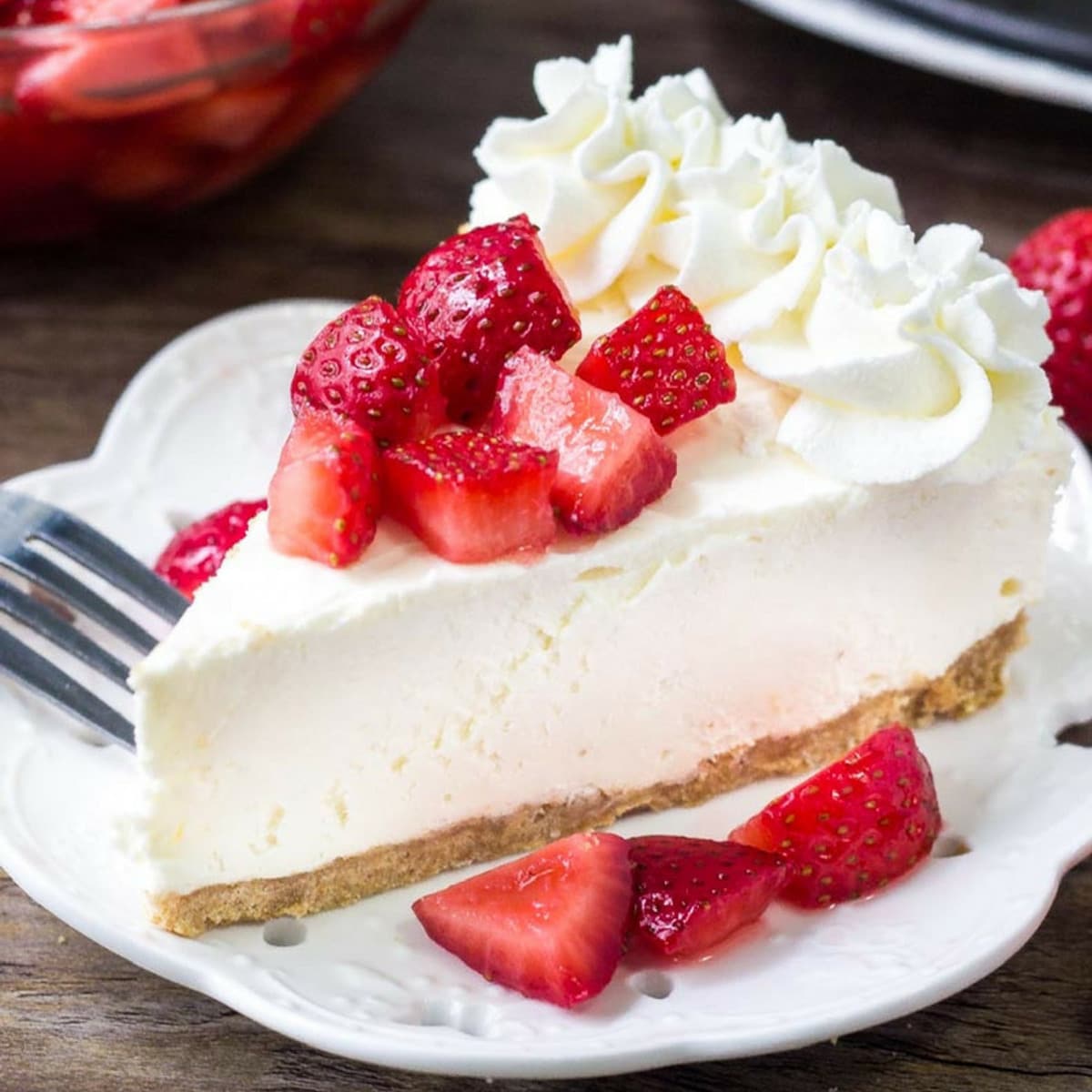 No Bake Cheesecake slice on white plate with strawberries
