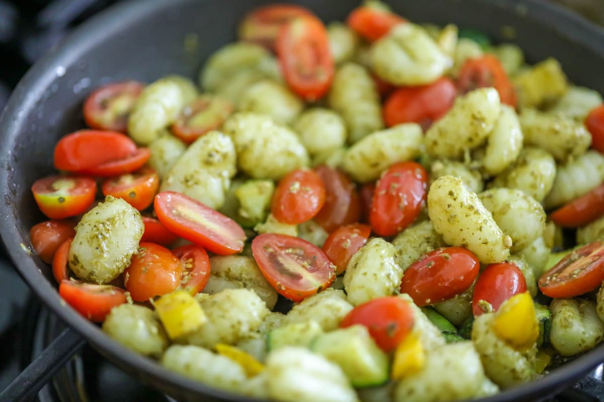 Gnocchi and tomatoes in a pesto sauce.