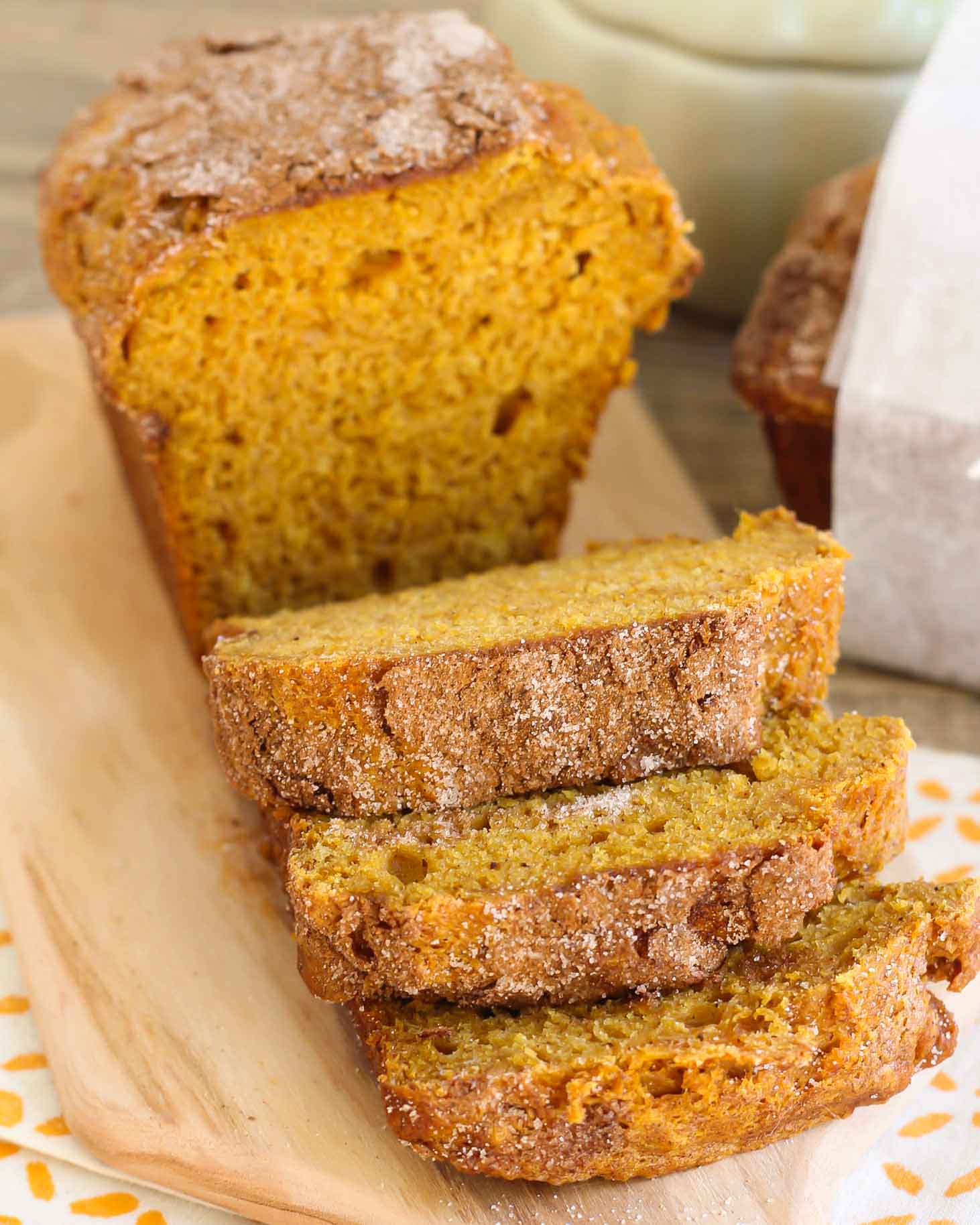 Best Pumpkin Bread loaf cut into slices on a cutting board.