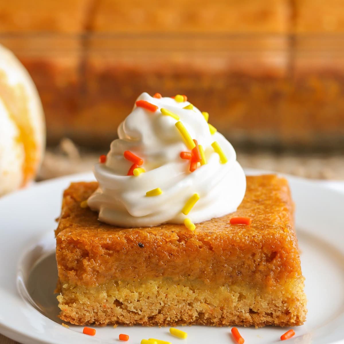 Fall dessert recipes - slice of pumpkin gooey butter cake on a plate.