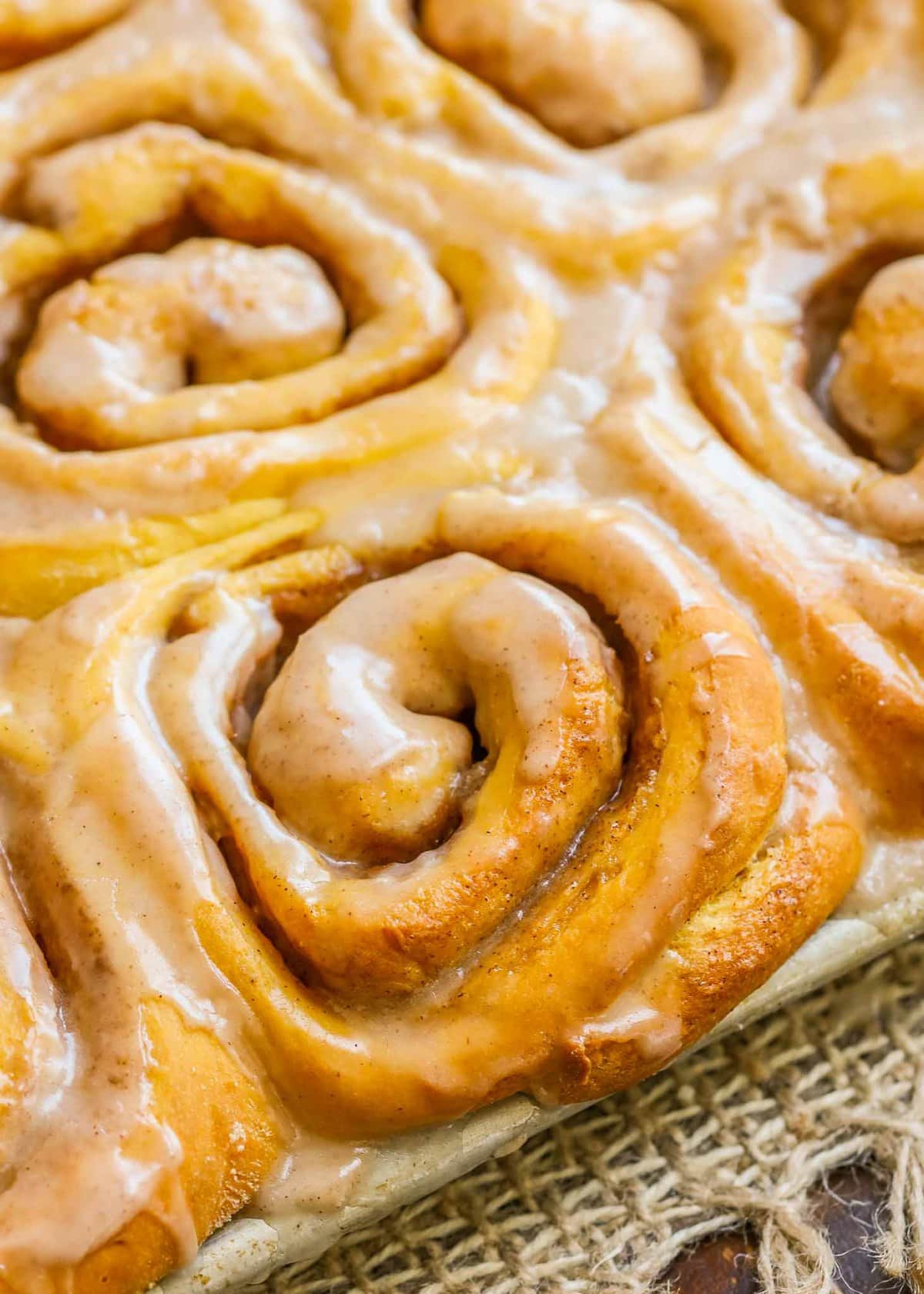 Close up of Soft Pumpkin Cinnamon Rolls lightly glazed.