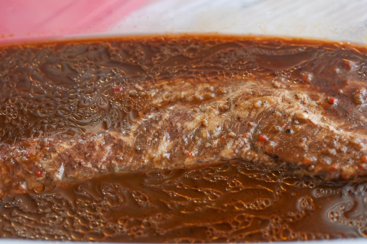 Flat iron marinating in best steak marinade inside a ziploc bag.