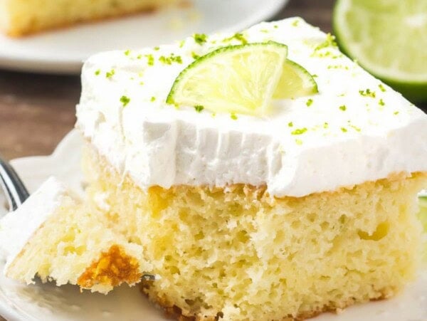 Slice of key lime cake topped with fresh lime.