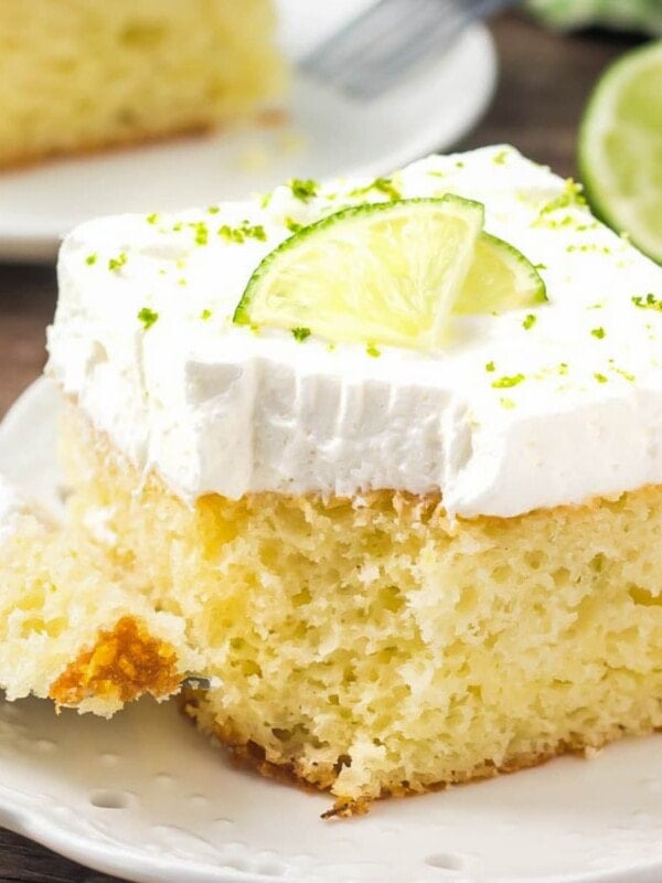 Slice of key lime cake topped with fresh lime.