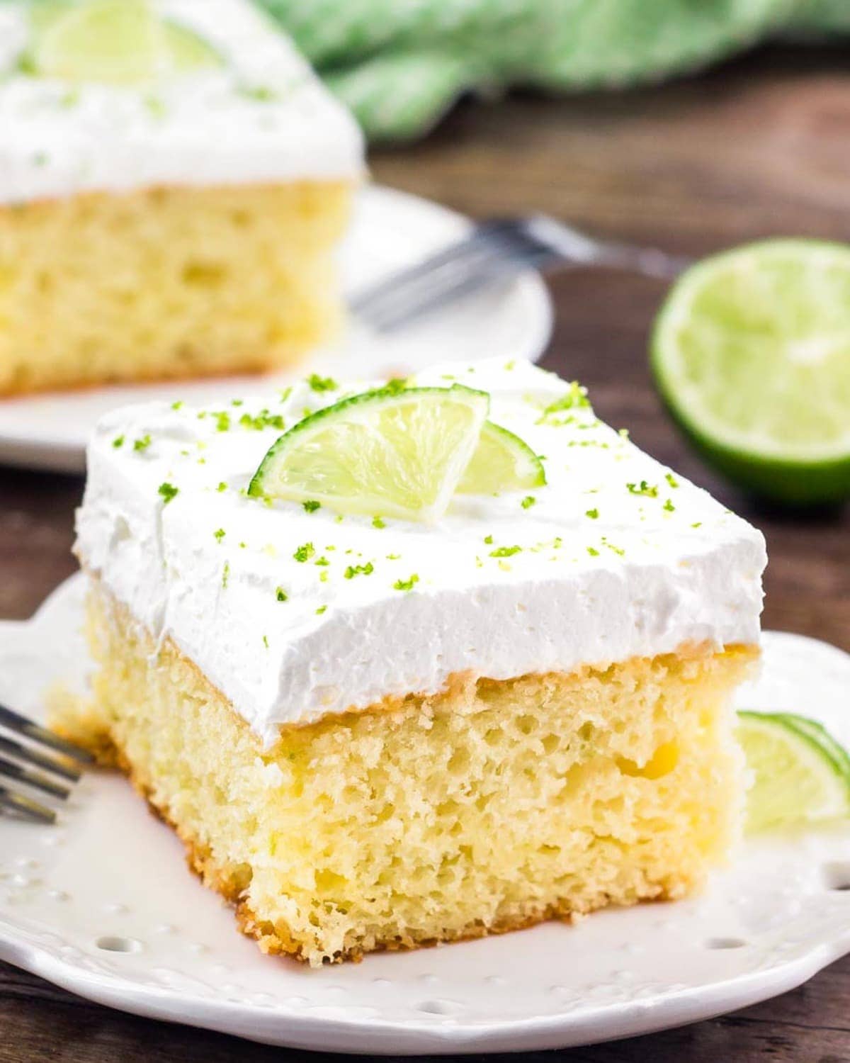 Slice of Key Lime Pie Cake on a white plate.