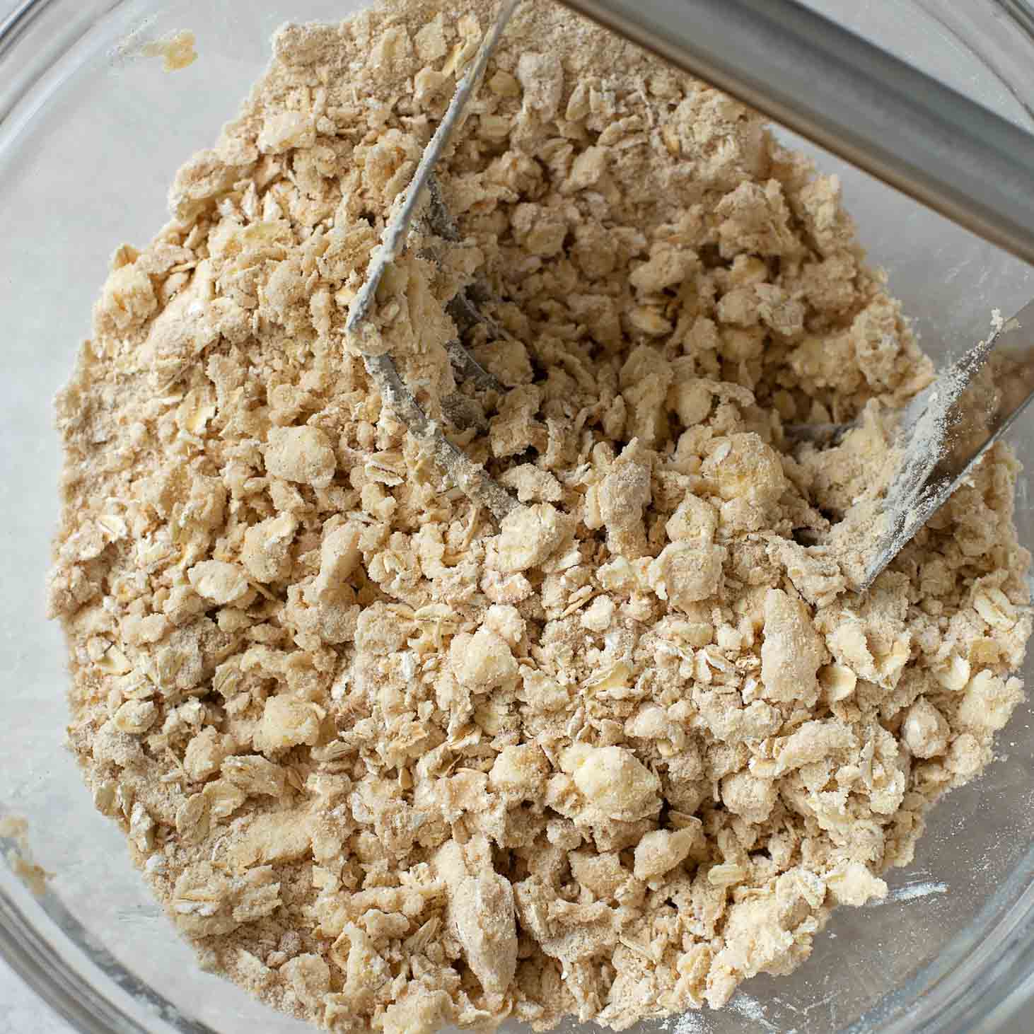 Mixing the crumb topping for triple berry pie.