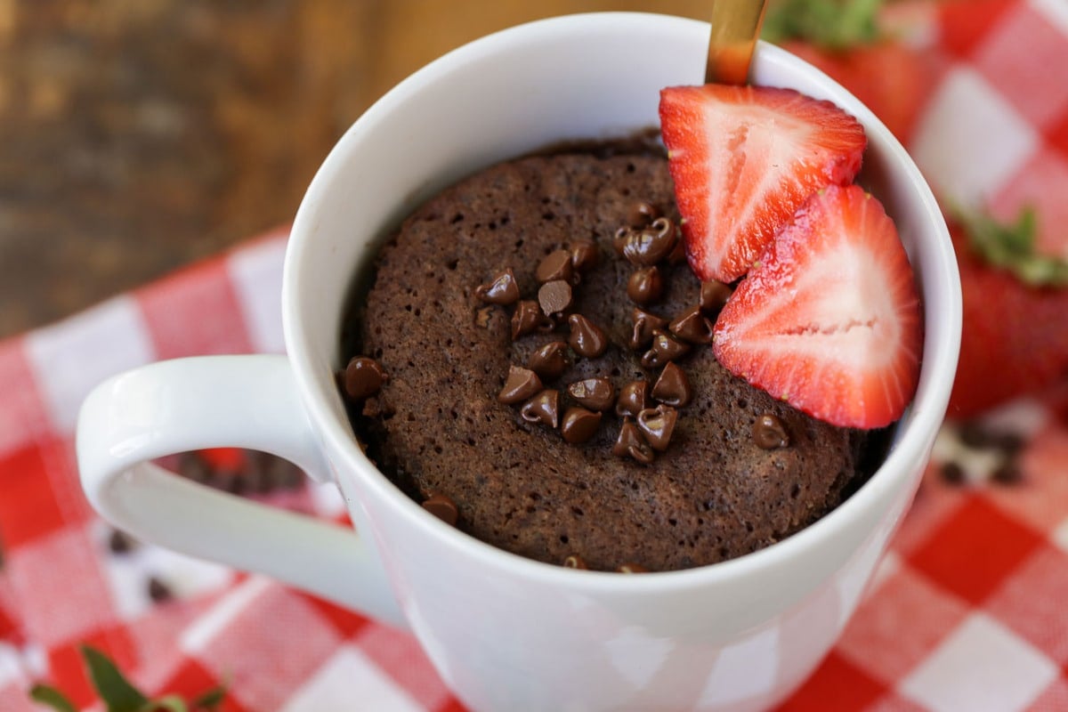 Chocolate Cake Recipes - Chocolate mug cake topped with strawberry slices in a white mug.