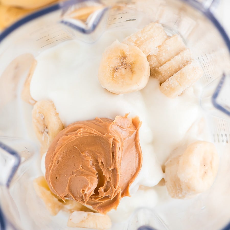 Ingredients in blender to make banana peanut butter smoothie.