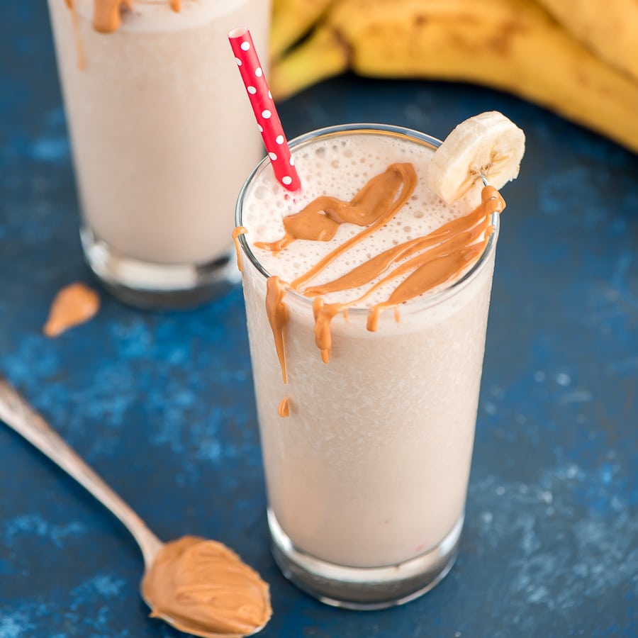 Peanut Butter and Banana Smoothie in a glass with a straw.