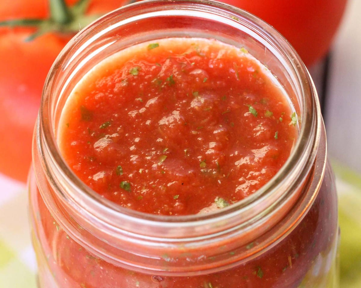 Cold appetizers - close up of a jar filled with homemade salsa.