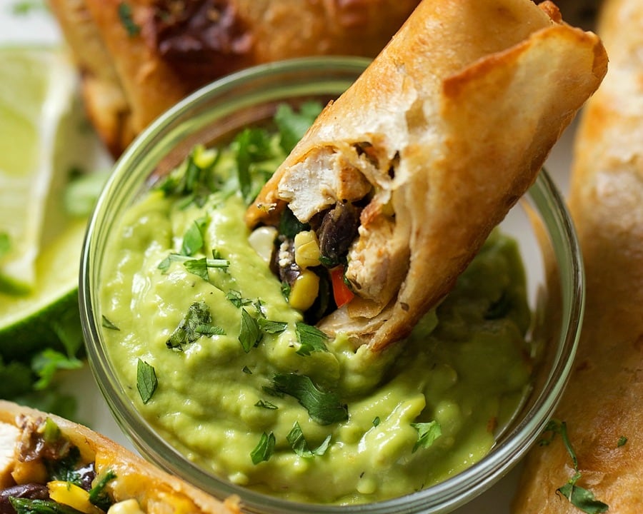 Finger food appetizers - dipping southwest egg rolls into guacamole.