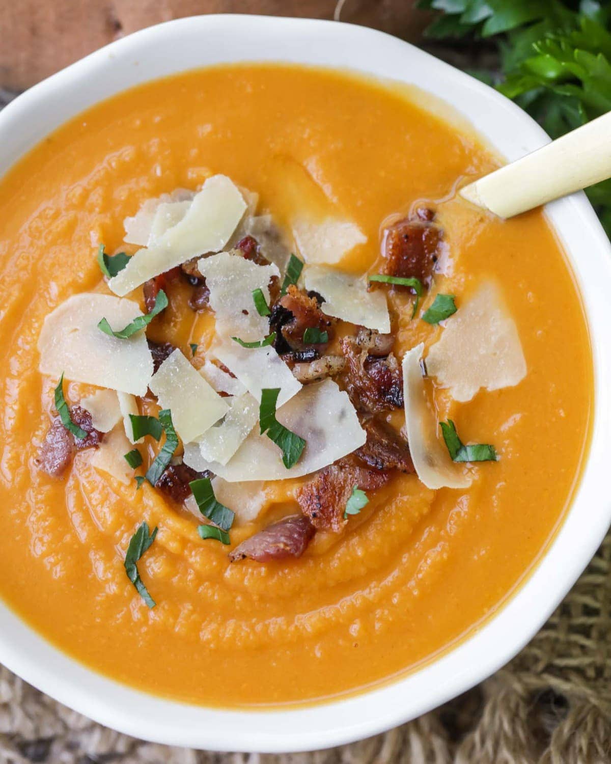 Sweet Potato Soup topped with bacon bits and shaved parmesan