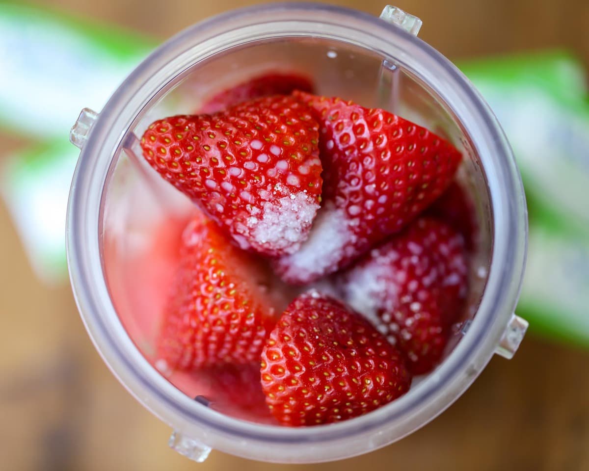 Strawberries and watermelon in a blender for making watermelon smoothie.