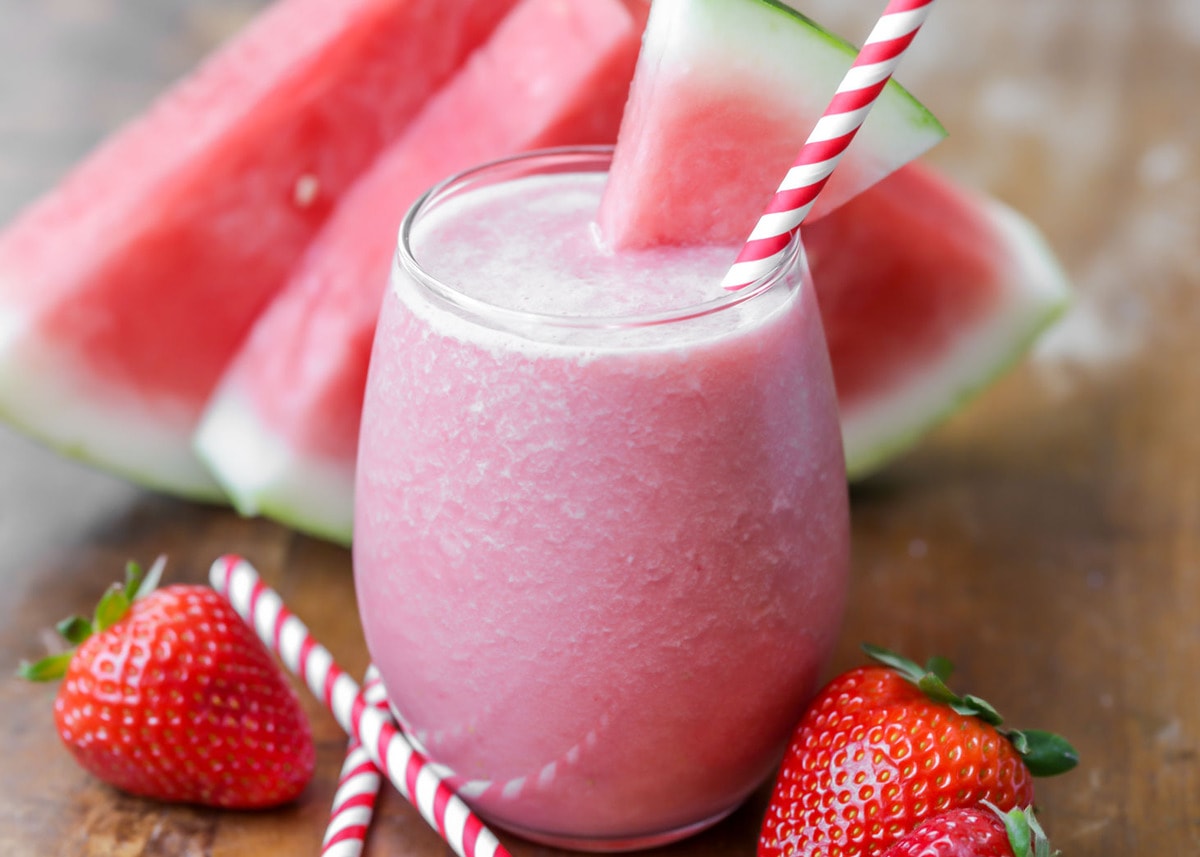 Watermelon Smoothie in a glass with a colorful straw.