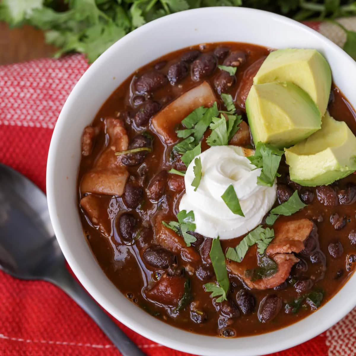 Black Bean Soup garnished with sour cream and avocado