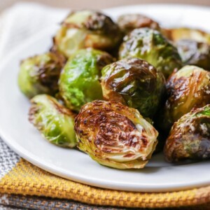 Roasted brussels sprouts on white plate.