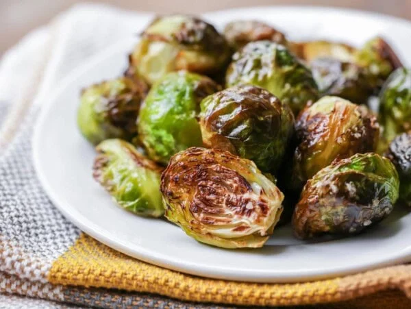 Roasted brussels sprouts on white plate.