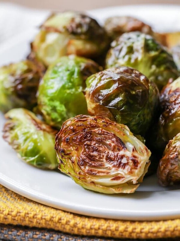 Roasted brussels sprouts on white plate.