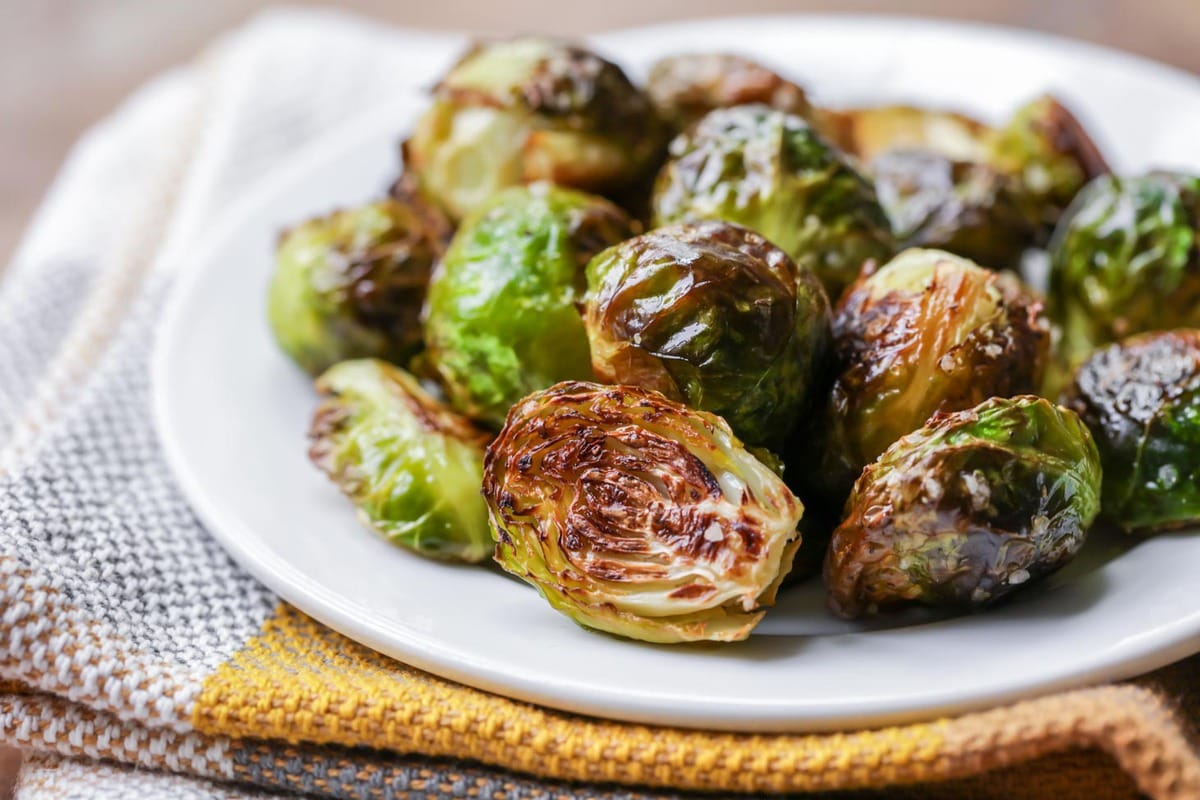 Vegetable side dishes - a plate piled with roasted brussel sprouts.