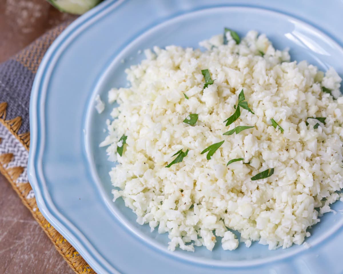 Vegetable side dishes - a blue plate filled with cauliflower rice.
