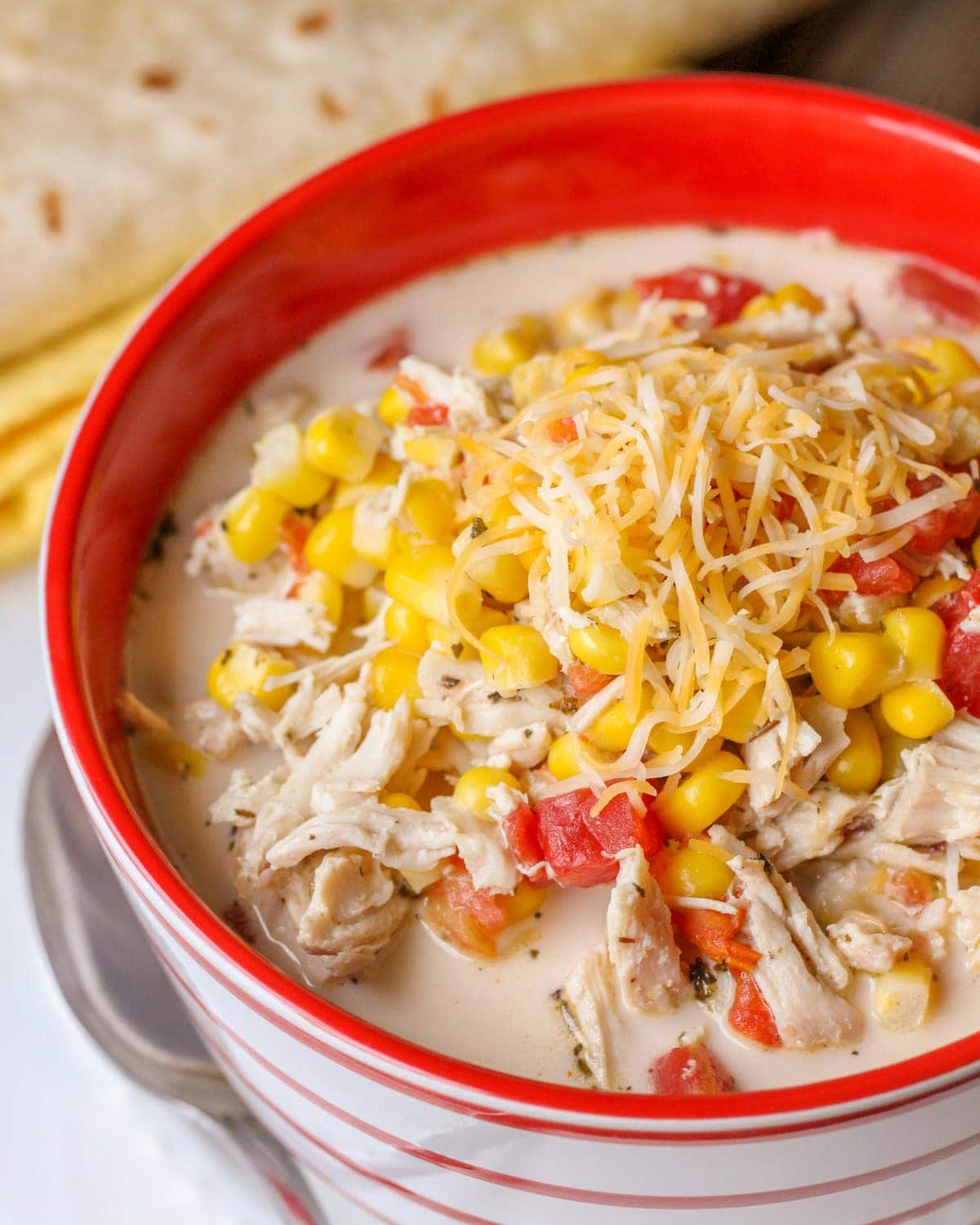 Mexican Chicken Corn Soup in a bowl with a spoon