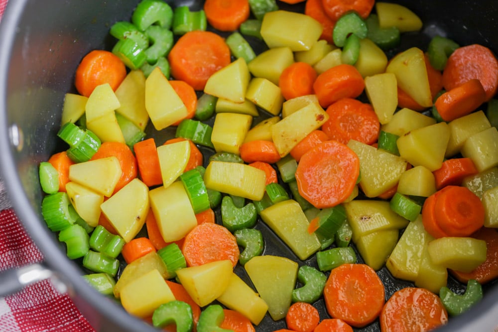 Cooking chopped veggies in a pot.