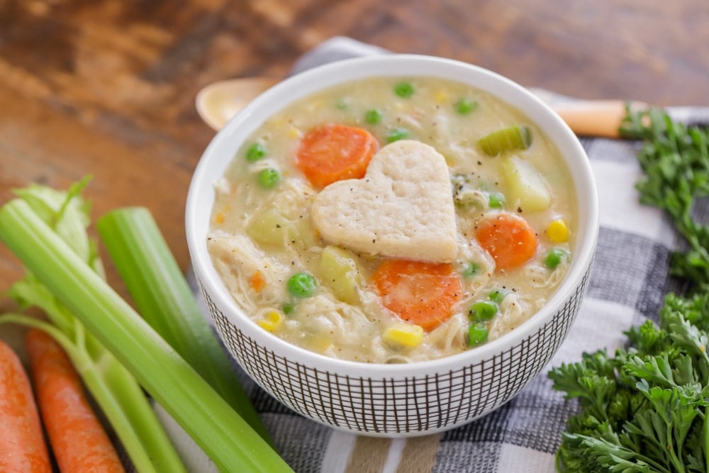 Crockpot chicken recipes - bowl of chicken pot pie soup with heart crust on top.