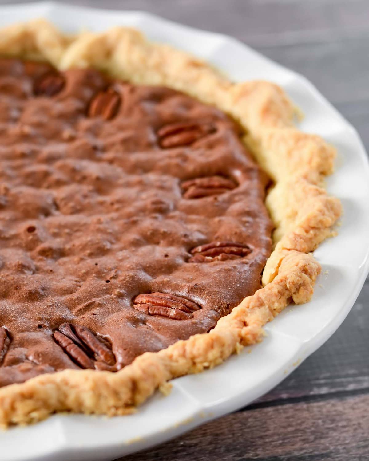 Chocolate Pecan Pie in a white pie pan